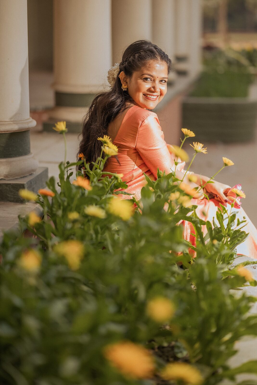 Bride-to-be behind marigolds in the garden at Ram Bagiya, Prayagraj