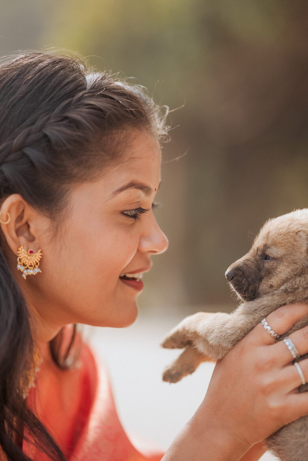 Bride-to-be holding a puppy during the Ram Bagiya pre-wedding shoot, Prayagraj