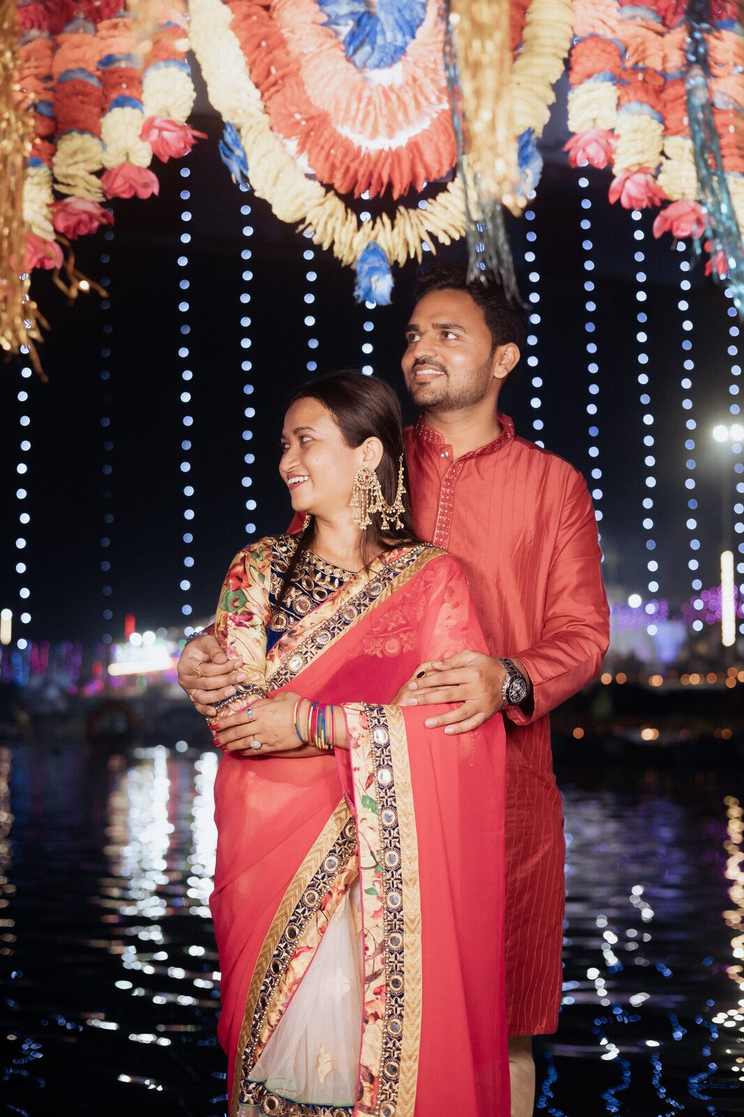 Couple against a curtain of lights on the Mandakini at Ram Ghat, Chitrakoot