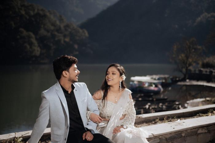 Couple laughing beside the boats at Sattal Lake, Nainital