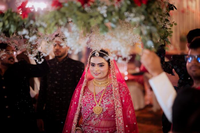 Bride's entry with family showering petals at an Allahabad wedding