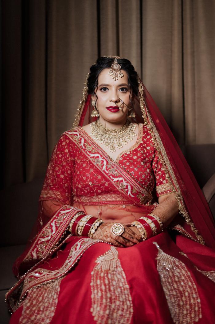 Bride seated in her red lehenga before the ceremony, Allahabad