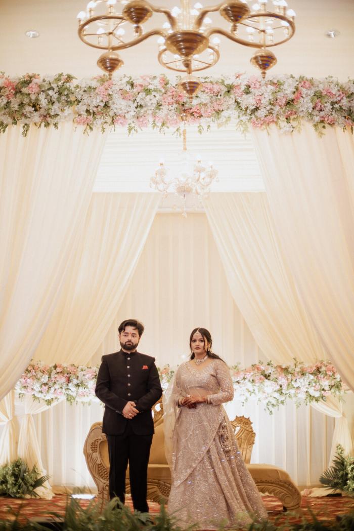 Bride and groom at the white floral mandap, Allahabad wedding photography