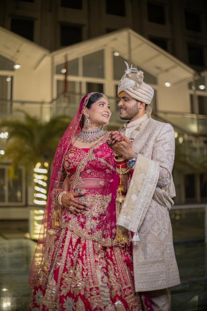 Bride and groom in the hotel courtyard on their wedding day, Prayagraj