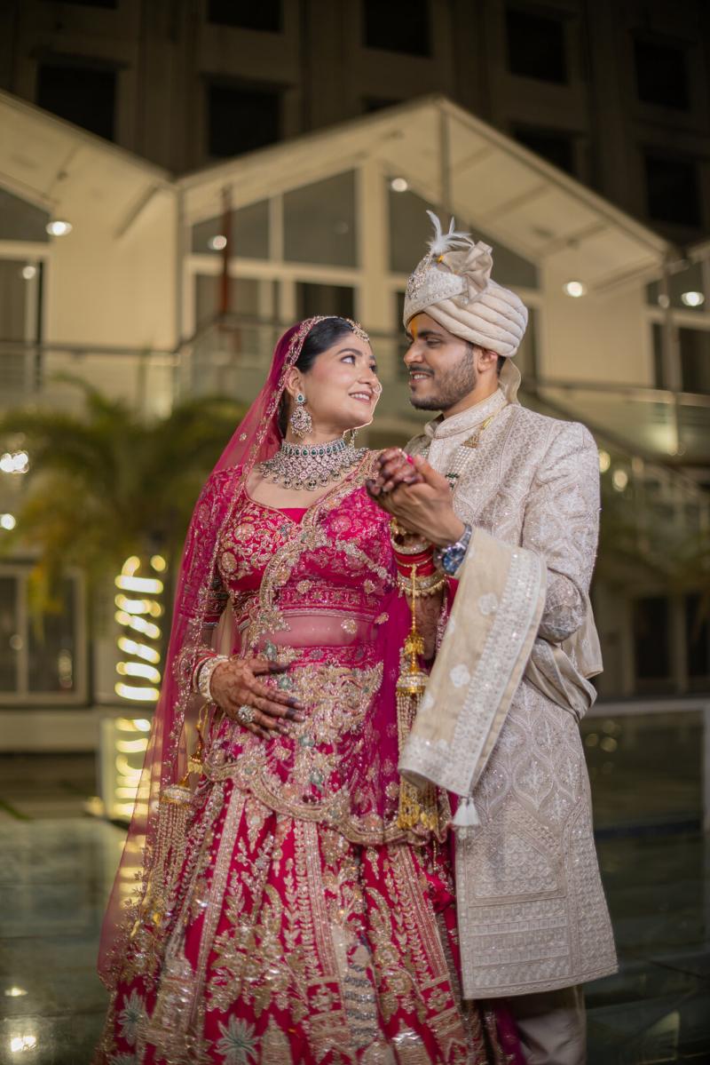 Bride and groom in the hotel courtyard on their wedding day, Prayagraj